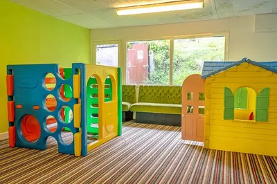 a room with different types of play equipment at Finest Retreats - Lanteglos Villa in Camelford