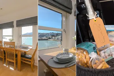 a kitchen and a dining room with a table and a window at Harts Loft - On Beach - Panoramic Sea Views - By Harbour in St Ives