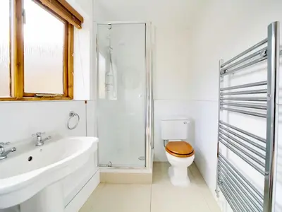 a bathroom with a toilet and a sink and a shower at Casa Piedra in Polzeath