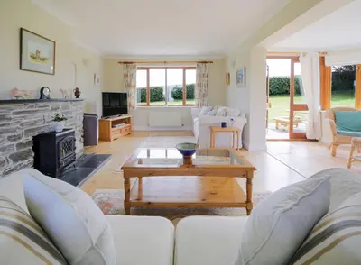 a living room with a couch and a table at Chy Petroc in Polzeath