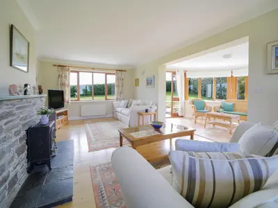 a living room with couches and a fireplace at Chy Petroc in Polzeath