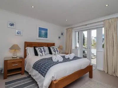 a bedroom with a bed with two towels on it at Sea Breeze in Carbis Bay