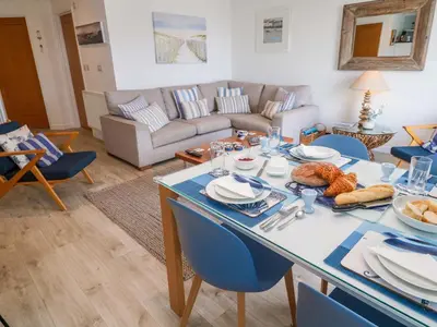 a living room with a table with food on it at Sea Breeze in Carbis Bay