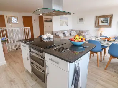 a kitchen with a counter top with a bowl of fruit on it at Sea Breeze in Carbis Bay