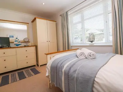 a bedroom with a bed with towels on it at Sea Breeze in Carbis Bay