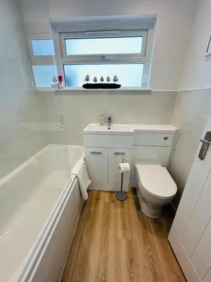 a bathroom with a sink and a toilet and a window at Moogara in Gorran Haven
