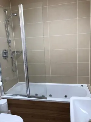 a bathroom with a shower and a bath tub at Retallack hot tub lodge - 4 ensuites - luxury stay in Saint Columb Major