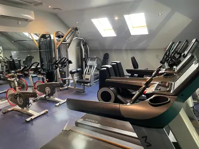 a gym with lots of cardio equipment in a room at Retallack hot tub lodge - 4 ensuites - luxury stay in Saint Columb Major