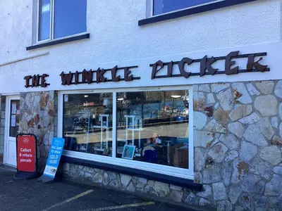 a building with a sign that reads the whale attack at Charming Fishing Cottage in Polruan