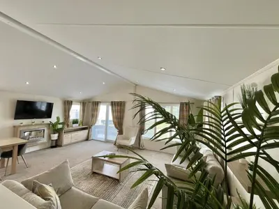 a living room with a couch and a tv at Sea Breeze Villa near to Newquay sleeping 6 guests in Newquay