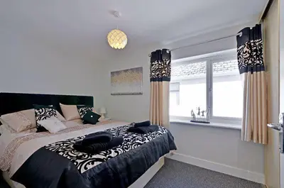 a bedroom with a large bed and a window at Foxwood in Kenwyn
