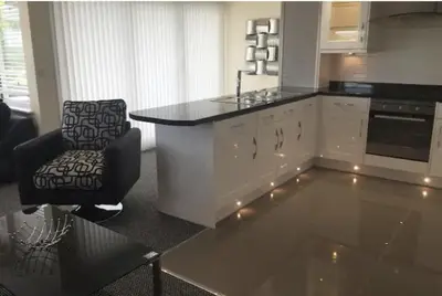 a kitchen with a counter and a chair in a room at Foxwood in Kenwyn