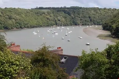 a group of boats in a river with trees at Pencarrick in Kenwyn