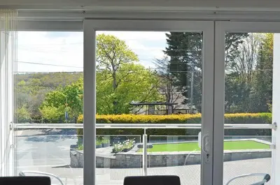an open window with a view of a yard at Pencarrick in Kenwyn