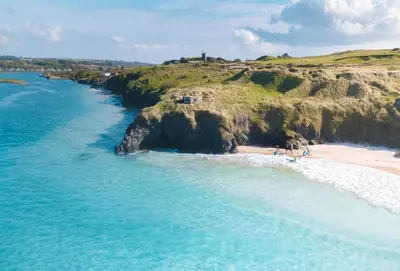 an aerial view of a beach next to the ocean at Puffin Way in Hayle