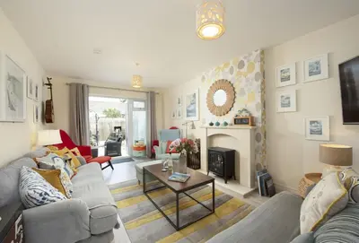 a living room with a couch and a fire place at Puffin Way in Hayle