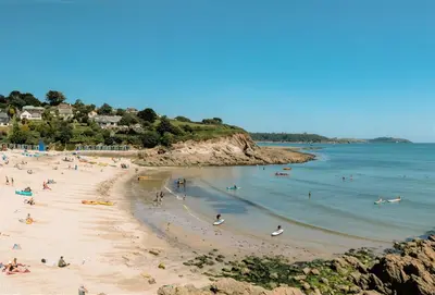 a group of people on a beach in the water at The Old Chapel in Saint Clement
