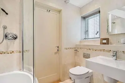 a bathroom with a toilet and a sink and a shower at The Old Chapel in Saint Clement