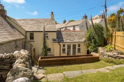 a house with a garden in front of it at Hilldene in Tintagel