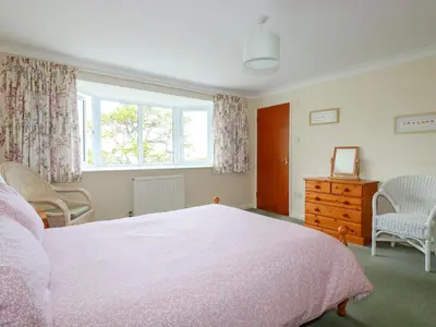 a bedroom with a bed and a window and a dresser at Godrevy View in St Ives