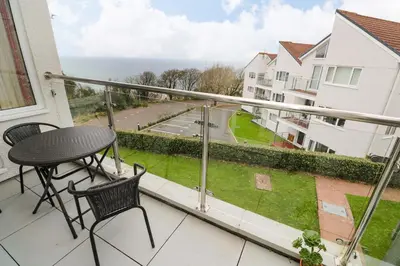 a balcony with a table and chairs and a view at Godrevy View in St Ives