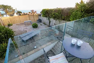 a patio with a table and a table and chairs at Azur in St Ives