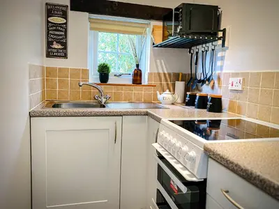 a kitchen with a sink and a stove top oven at Hawthorn in Bude