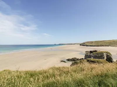 a beach with rocks and the ocean in the background at The Old Piggery in Truro