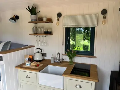 a small kitchen with a sink and a window at Kilden Hut - Perranwell Station in Perranwell