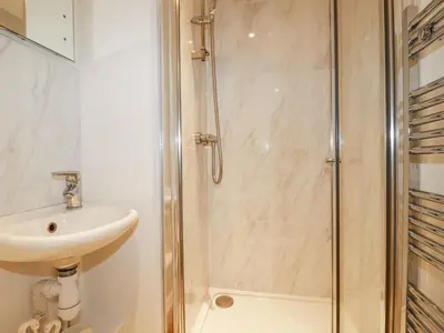 a bathroom with a shower and a sink at Trelowth Chapel in St Austell