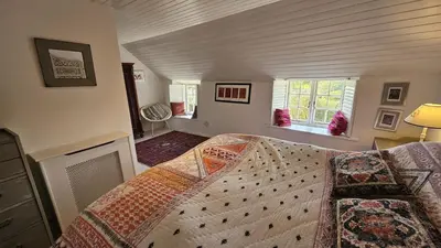 a bedroom with a bed in a room at Sophie's Cottage in Philleigh