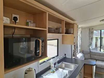 a kitchen and a sink in a tiny caravan at Kernow 237 in Newquay