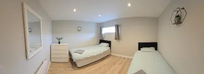 a bedroom with a bed and a mirror at Acklington 2 bedroom property in Menheniot