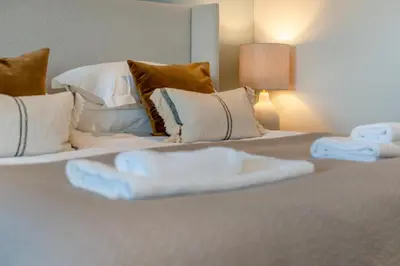 a bedroom with two beds with white sheets and pillows at 4 Bed in St. Merryn oc-f31095 in St Merryn