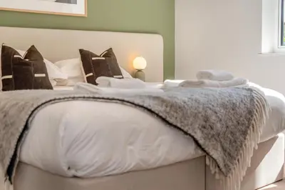 a bedroom with a white bed with a blanket on it at 4 Bed in St. Merryn oc-f31095 in St Merryn