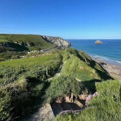 a path on a cliff next to the ocean at Old Chapel House in Tintagel