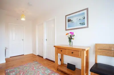 a room with a vase of flowers on a table at Creek View in Feock