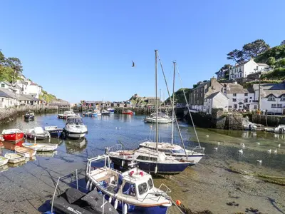 a group of boats are docked in a harbor at Harbour View in Looe