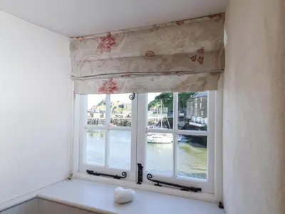 a window with a view of the water at Harbour View in Looe