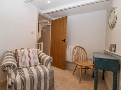 a living room with a couch and a desk at Harbour View in Looe