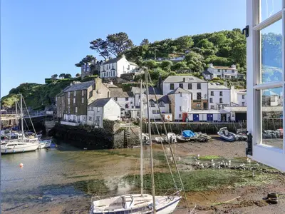 a view from a window of a small harbor with boats at Harbour View in Looe