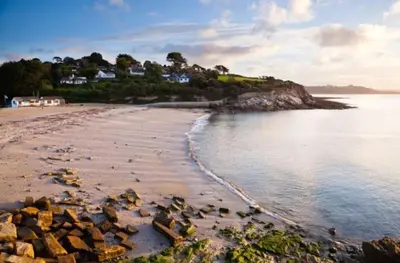 a view of a beach with rocks in the water at Cabin by Beach & Nature Reserve Mon & Fri Check in Days Swanpool Falmouth Cornwall in Falmouth