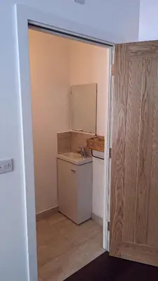 a small bathroom with a sink and a mirror at Hayle - 2 bedrooms house with EV parking, 4 beds in Hayle