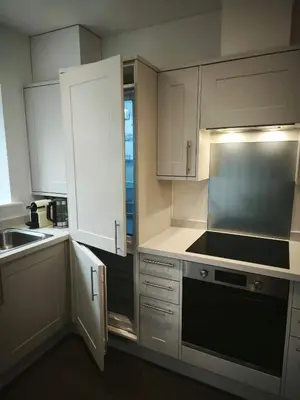 a kitchen with white cabinets and a stove top oven at Hayle - 2 bedrooms house with EV parking, 4 beds in Hayle