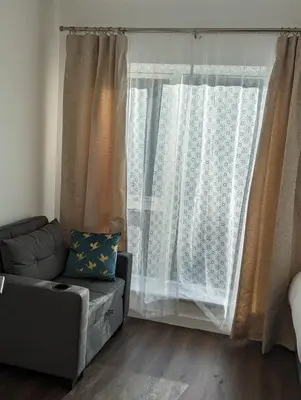 a living room with a couch and a window at Hayle - 2 bedrooms house with EV parking, 4 beds in Hayle