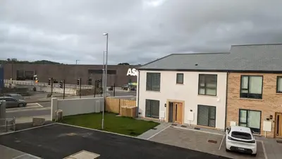 a white house with a car parked in a parking lot at Hayle - 2 bedrooms house with EV parking, 4 beds in Hayle