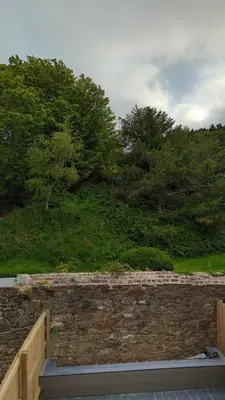 a stone retaining wall with trees in the background at Hayle - 2 bedrooms house with EV parking, 4 beds in Hayle