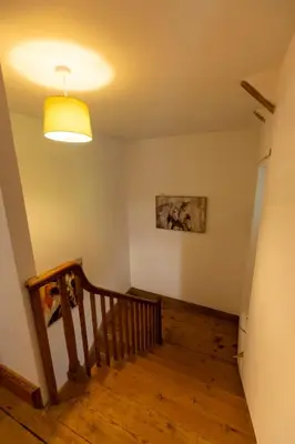 a room with a staircase with a light on the ceiling at The perfect bolt hole in Quethiock