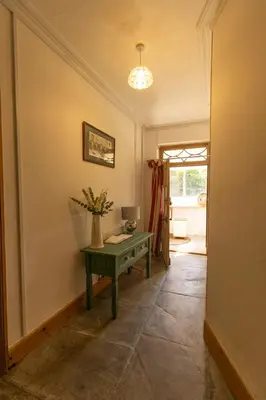 a hallway with a green table in a room at The perfect bolt hole in Quethiock