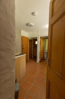 a kitchen with a tile floor and a door at The perfect bolt hole in Quethiock